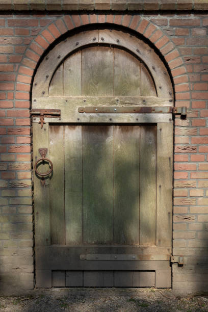 Old classic simple wooden door in a stone wall
