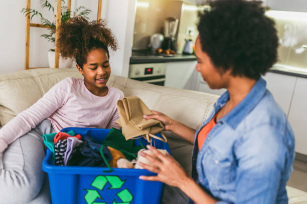 istock Mother and daughter sorting out clothes in boxes to donate at home 1388343324