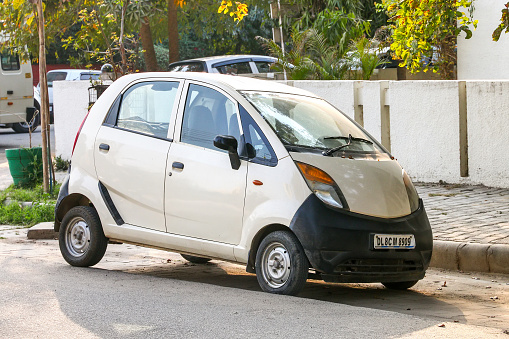 Gurgaon, India - March 3, 2022: Urban mini car Tata Nano in a city street.