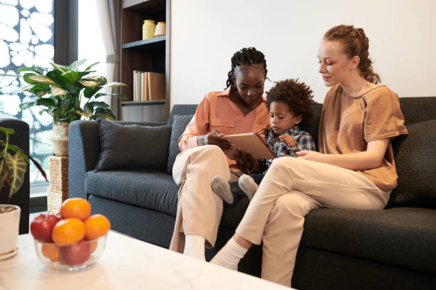 istock Mothers and Son Playing Game on Tablet 1388343756