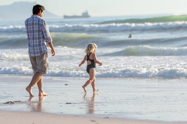 istock Father playing with her daughter on the beach 1388345394