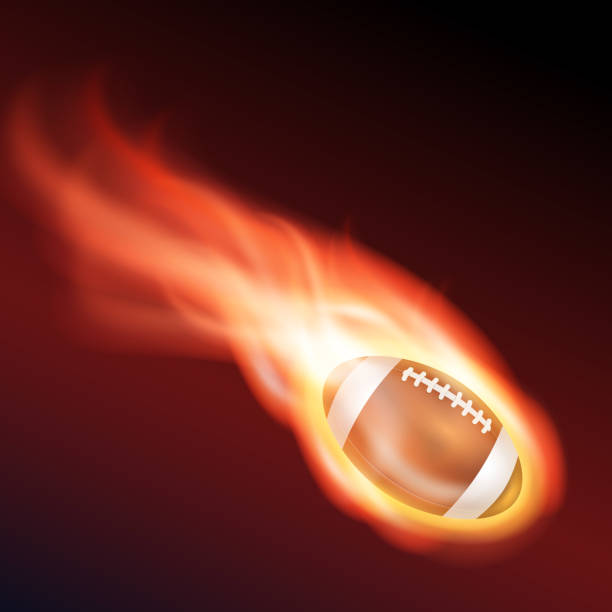 istock Flying flaming American football ball on a black background 1388348548