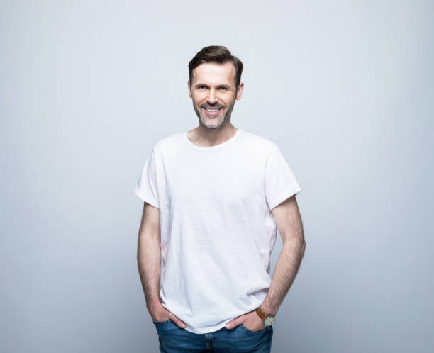 istock Smiling handsome man standing with hands in pockets 1388349786