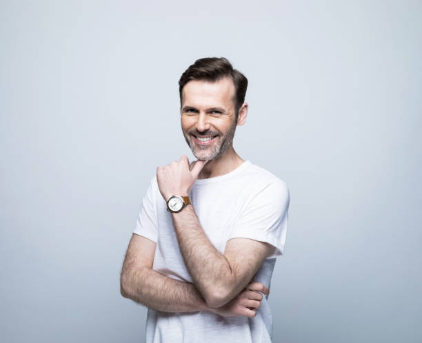 istock Smiling handsome man with hand on chin 1388349826