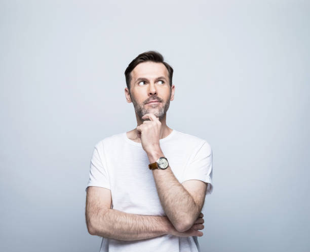 istock Thoughtful man with hand on chin looking away 1388349917