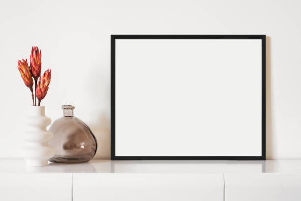 istock Artwork mock-up in interior design. Blank landscape orientation picture frame on a cupboard 1388350046