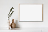 istock Artwork mock-up in interior design. Blank landscape orientation picture frame on a cupboard 1388350050