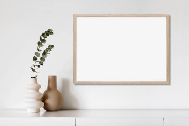 Artwork mock-up in interior design. Blank landscape orientation picture frame on a cupboard View of modern interior design. Minimalism boho style. Blank white empty frame for painting or poster. horizontal stock pictures, royalty-free photos & images