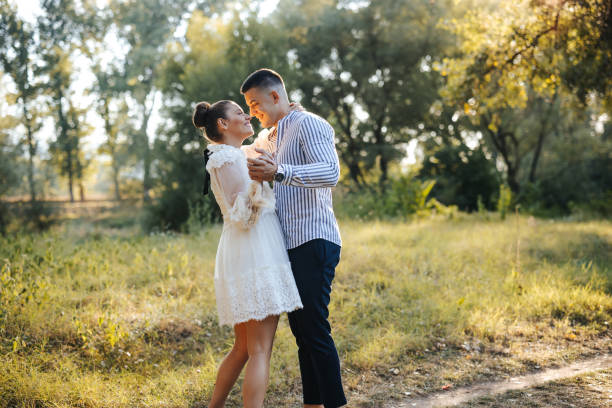 istock Romantic young couple dancing in nature at sunset 1388351489