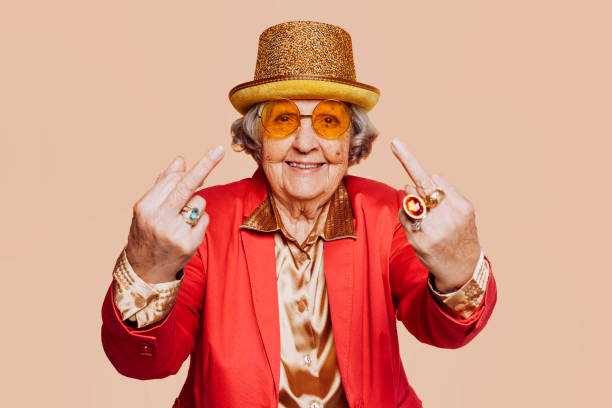 istock Funny elderly grandmother showing middle finger 1388351615