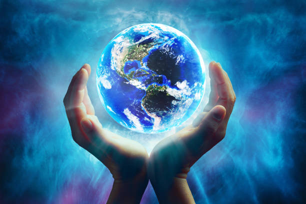 istock Conceptual mother earth with surrounding hands 1388352392