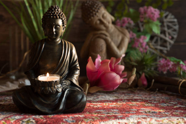 istock Buddha in the ambience with candlelight and atmospheric lighting 1388355615