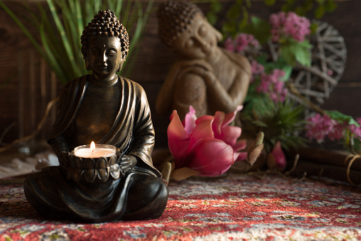 Buddha in the ambience with candlelight and atmospheric lighting