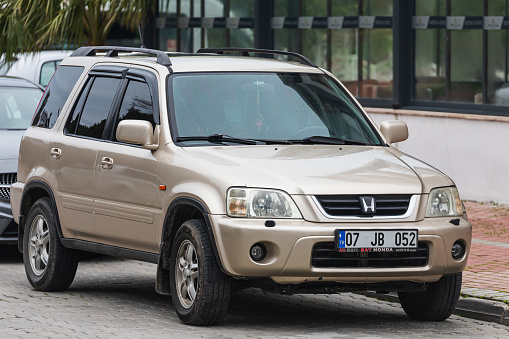 Antalya; Turkey – March 04 2022:   beige Honda CR-V  is parked  on the street on a warm summer day against the   parking