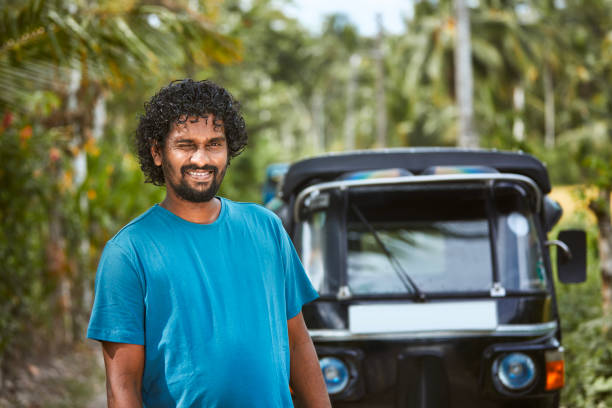 Portrait of smiling tuk tuk driver on rural road Portrait of smiling tuk tuk driver on rural road. Popular three wheeled motorcycle in Sri Lanka. "n taxi sri lanka stock pictures, royalty-free photos & images