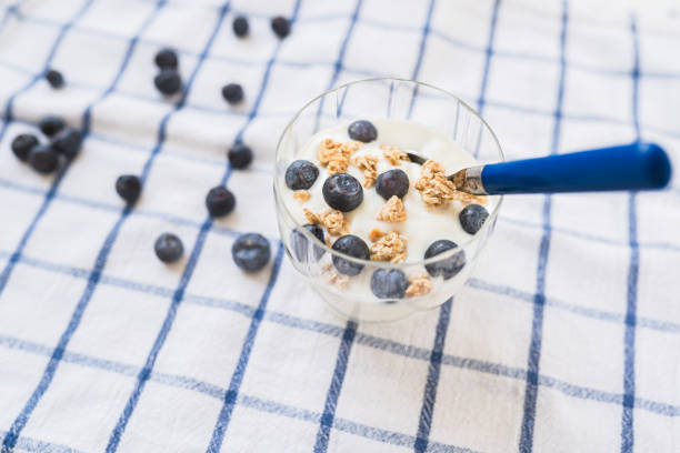 yogurt with cereal and blueberries. Healthy low calorie breakfast. Healthy blueberries with natural yogurt and oatmeal flakes