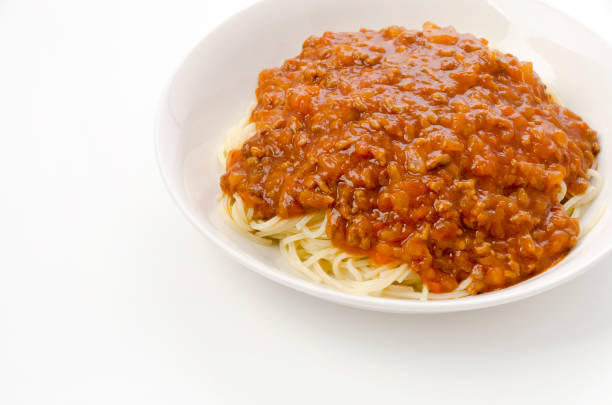 Food in disposable lunch box. Pasta with meat and salad.