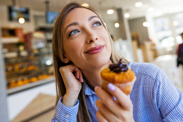 istock Customer is about to eat a cupcake in bakery 1388361747