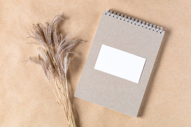 istock Open white paper empty blank of notepad for mock up with dried spikelets decoration on craft beige background. 1388363462