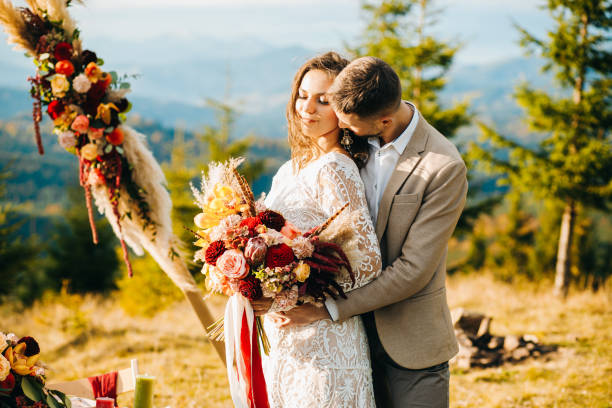 istock Happy couple hugging under wedding arch 1388364654