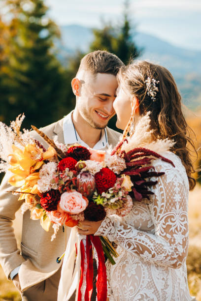 istock Happy couple hugging under wedding arch 1388364659