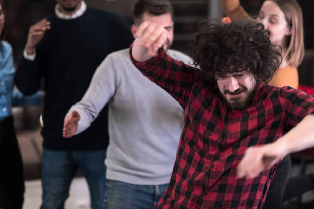 istock A group of young business people have fun playing interesting games while taking a break from work in a modern office. Selective focus 1388364661