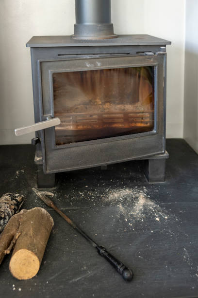 istock A log burner in a domestic lounge with a poker and ash on the hearth 1388366378