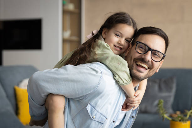 Little girl hugging her father stock photo