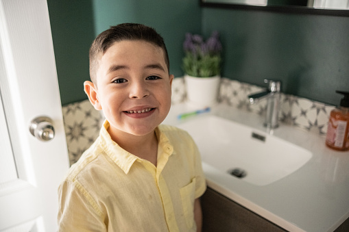 Portrait of a happy boy in the bathroom