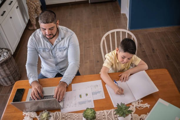 istock Boy studying and father working at home 1388370777