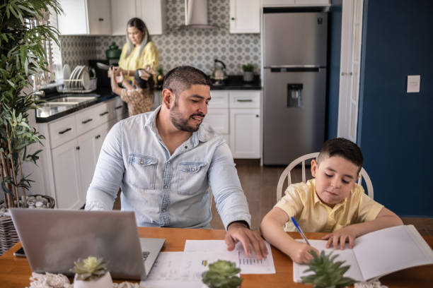 istock Man working from home and helping son with homework 1388370783