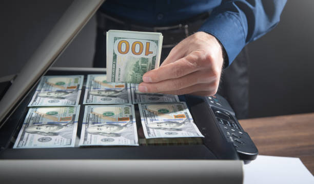 istock Man copying a money on a copy machine. 1388371381