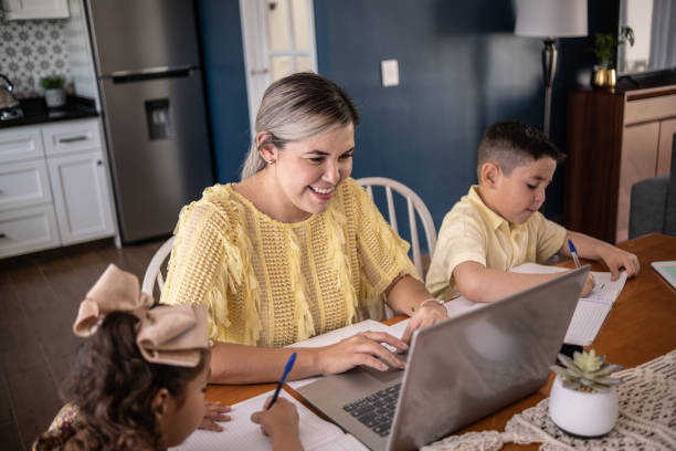 istock Latin mother working and children studying at home 1388371586