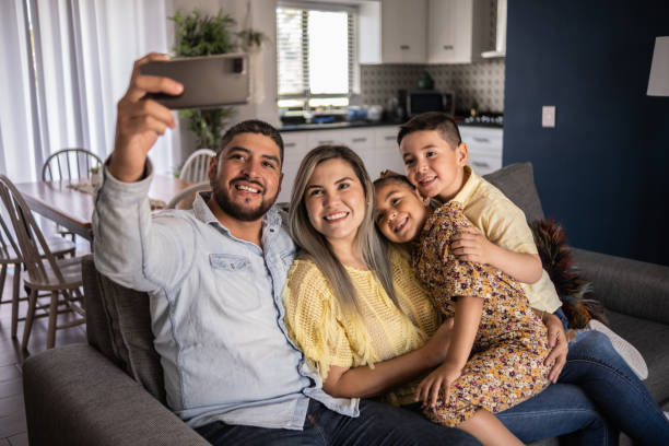 istock Happy family taking a selfie or doing a video call at home 1388371704