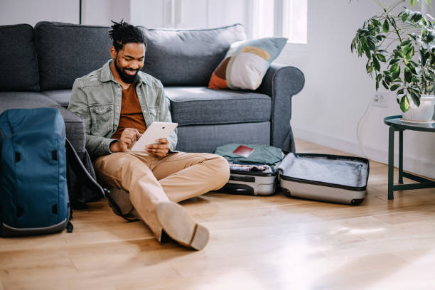 istock Young black man prepares quickly his traveler suitcase 1388372074