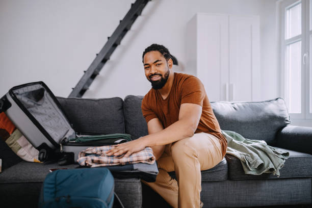 istock Young black man prepares quickly his traveler suitcase 1388372099