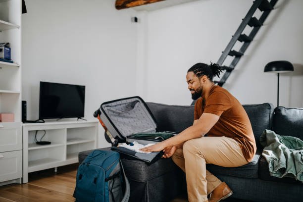istock Young black man prepares quickly his traveler suitcase 1388372100