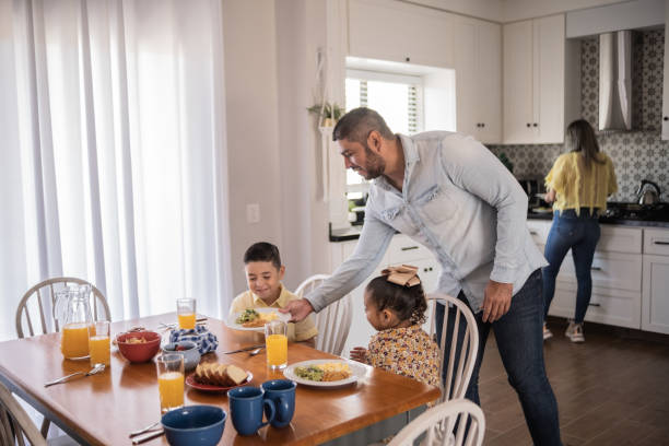 istock Father serving breakfast to children at home 1388372118
