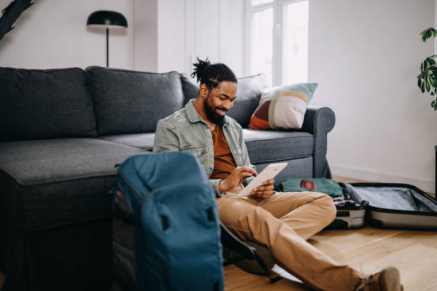 istock Young black man prepares quickly his traveler suitcase 1388372839