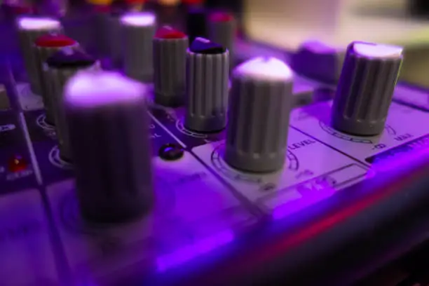 Macro shot of studio mixer under violet low light in stydio