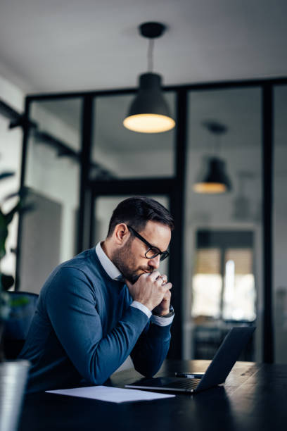istock Confident businessman, looking focused, working online, waiting 1388372920