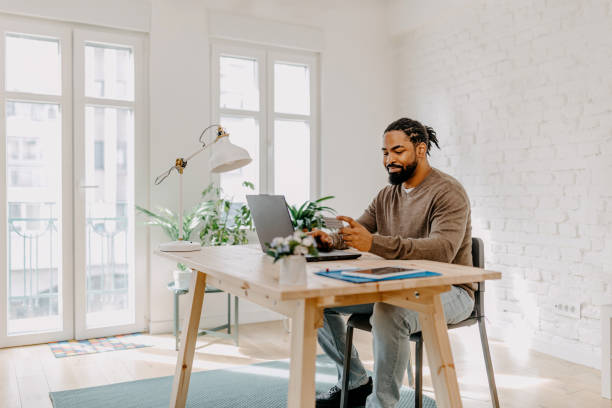 istock Young black man with credit card at his laptop 1388373547