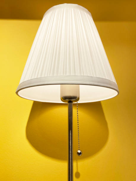 istock Table lamp, lamp shade with yellow wall background 1388374417