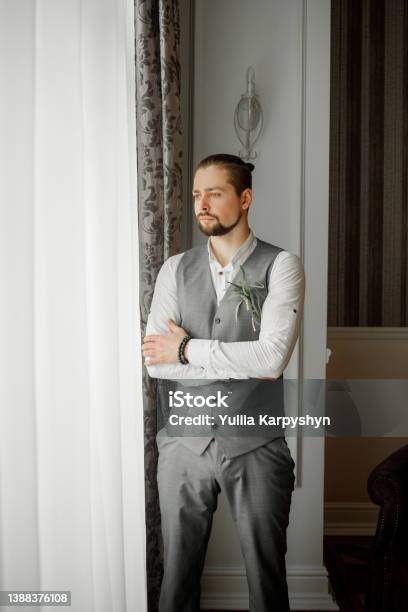 Portrait Of A Elegante Man In A Gray Suit Stock Photo - Download Image Now - 20-24 Years, Adult, Adults Only