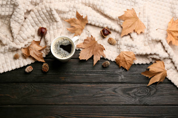istock Flat lay composition with hot drink and warm plaid on black wooden table, space for text 1388376170