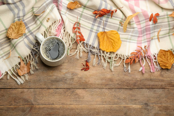 istock Composition with hot drink and warm plaid on wooden table, above view. Space for text 1388376740
