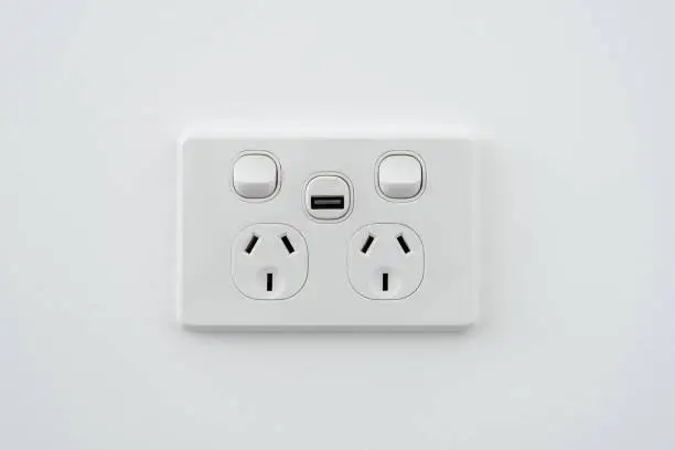 Photo of Socket with usb interface and switch on white wall