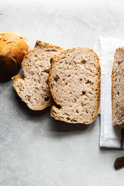 istock Sliced sourdough bread with nuts and nuts and oats. Top view. 1388377130
