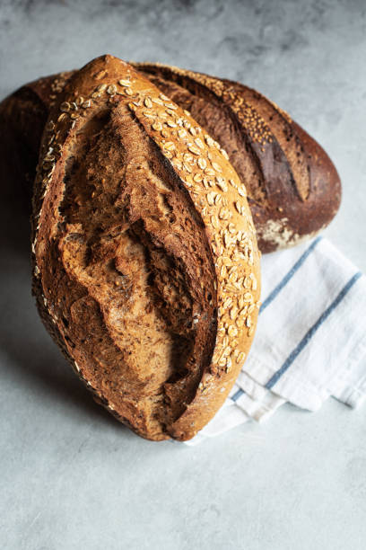 Two different sourdough bread on a gray background.