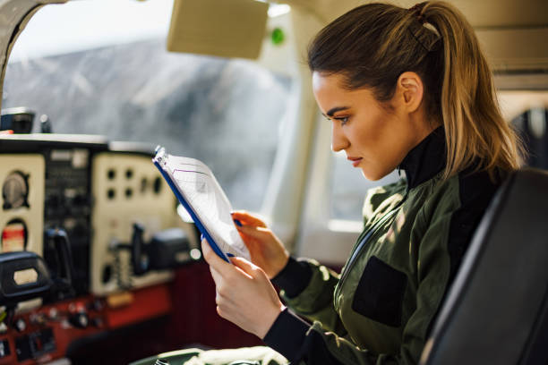istock Serious airplane inspector, comparing her notes to the airplane. 1388377281